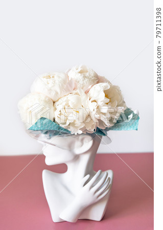 Bunch of white peonies in human head vase Bunch of white peonies in human head vase 79711398