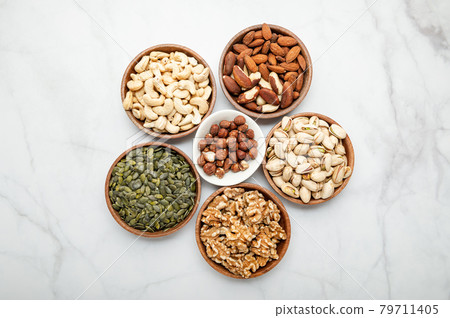 Different kind of nuts in wooden bowls 79711405