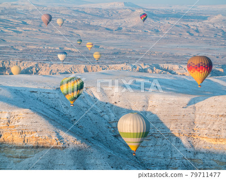 Colorful balloons over volcanic rocks in Cappadocia. Turkey. 79711477