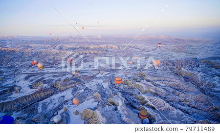 Colorful balloons over volcanic rocks in Cappadocia. Turkey. 79711489