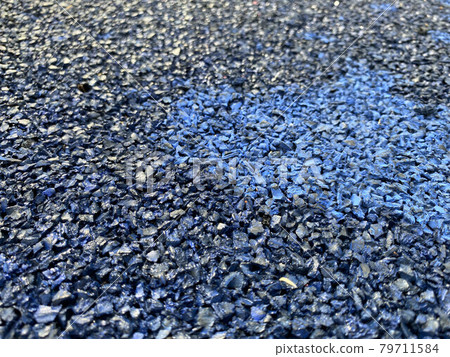 Blue rubber surface anti-traumatic safety tile on workout sports playground in public park or courtyard. The background. Texture Blue rubber surface anti-traumatic safety tile on workout sports playground in public park or courtyard. The background. Texture 79711584