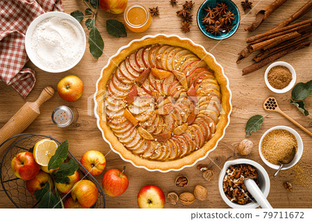 Thanksgiving autumn apple pie with fresh fruits and walnuts on wooden table, top view 79711672