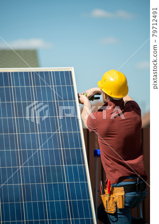 Worker Installing Photovoltaic Panel Worker Installing Photovoltaic Panel 79712491