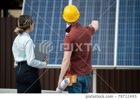 Contractor Showing Installed Solar Panels 79712493
