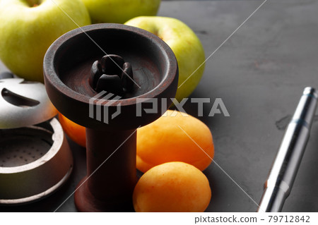 Hookah pipe and shaft with fruits on gray background 79712842
