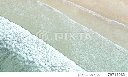Beautiful patterns created by waves lapping on the white sand beach [aerial view] [bird's-eye view] 79713983