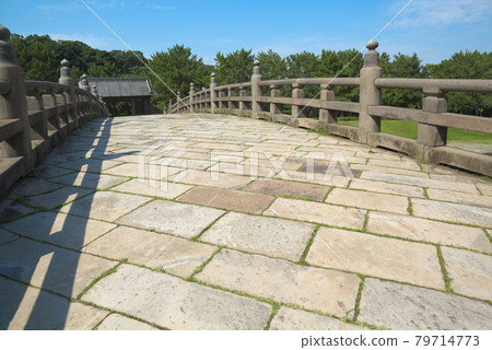 Nishida Bridge, one of the five stone bridges along the Kotsuki River. Stone pavement on the sidewalk. Nishida Bridge, one of the five stone bridges along the Kotsuki River. Stone pavement on the sidewalk. 79714773