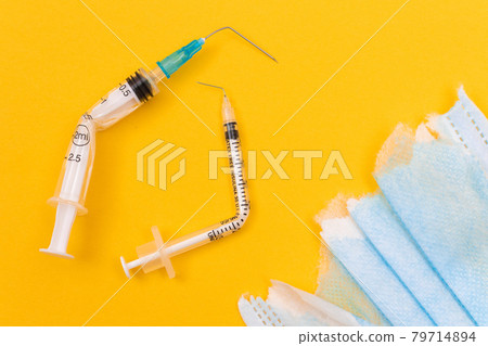 Broken Medical Syringe and Torn Medical Face Mask Broken Medical Syringe and Torn Medical Face Mask 79714894