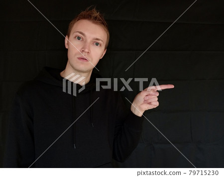 Right: A foreign man pointing at something on a black background Right: A foreign man pointing at something on a black background 79715230