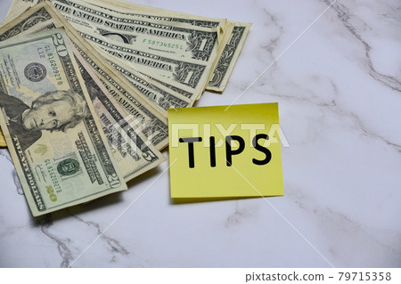 Text on yellow sticker note with US dollar bills Text on yellow sticker note with US dollar bills 79715358