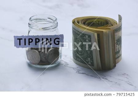 Text on white torn paper with coins in a glass jar and US dollar bills 79715425