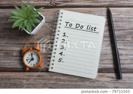 Text on notepad with pen, alarm clock and potted plant on wooden desk Text on notepad with pen, alarm clock and potted plant on wooden desk 79715503