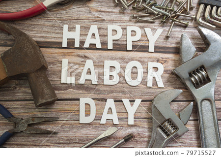 Happy labor day text with many handy tools on wooden background 79715527