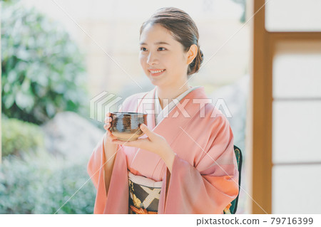 A woman in her 20s wearing a kimono drinking matcha A woman in her 20s wearing a kimono drinking matcha 79716399