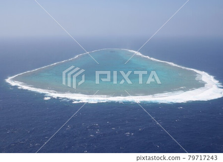 Okinotorishima, the southernmost island in Japan and an isolated part of Tokyo surrounded by coral reefs, seen from above the Philippine Sea Okinotorishima, the southernmost island in Japan and an isolated part of Tokyo surrounded by coral reefs, seen from above the Philippine Sea 79717243