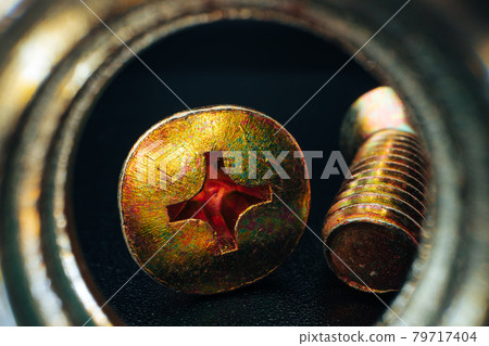 Metal screws and nuts on black background 79717404