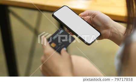 Close up female hand hold credit card and smartphone with blank empty screen, Online shopping Close up female hand hold credit card and smartphone with blank empty screen, Online shopping 79717858