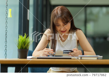 Female doing payment on online shopping application via mobile phone Female doing payment on online shopping application via mobile phone 79717862
