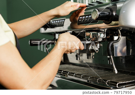 Woman coffee shop worker preparing coffee on professional coffee machine 79717950