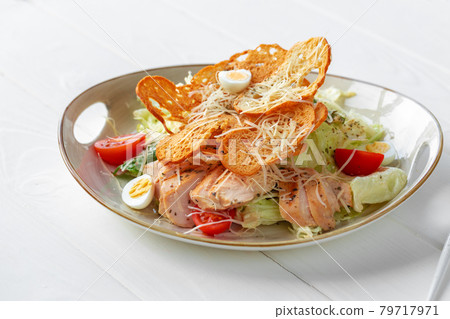 Caesar salad with grilled chicken on white wooden background 79717971