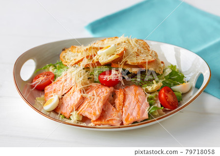 Caesar salad with grilled chicken on white wooden background 79718058