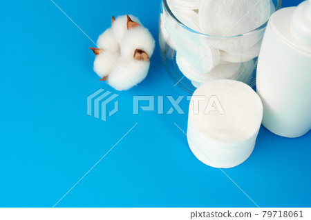 Stack of cotton discs and skicare cosmetic bottle Stack of cotton discs and skicare cosmetic bottle 79718061
