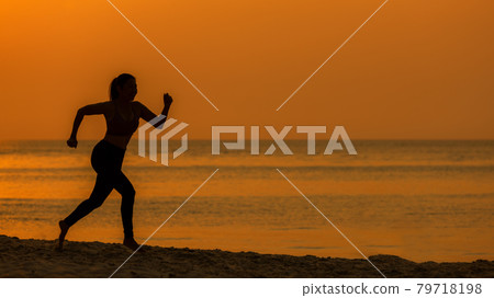 Silhouette athletic woman jogging exercise and relax and freedom on sand beach. Silhouette athletic woman jogging exercise and relax and freedom on sand beach. 79718198