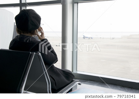 Woman calling phone at the airport Woman calling phone at the airport 79718341