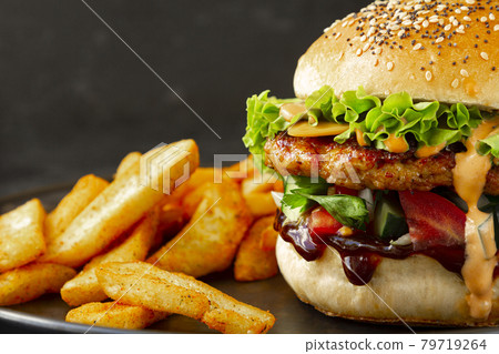 Close-up of Fresh tasty chicken burger with french fries Close-up of Fresh tasty chicken burger with french fries 79719264