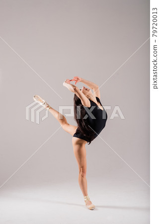 Flexible female, ballet dancer in black bodysuits Flexible female, ballet dancer in black bodysuits 79720013