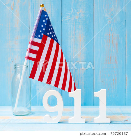 911 text and United States of America flag on wooden table background. Patriot Day, September, memorial and Never Forget concept 79720187