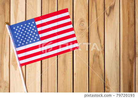 United States of America flag on wooden table background. USA holiday of Veterans, Memorial, Independence ( Fourth of July) and Labor Day concept United States of America flag on wooden table background. USA holiday of Veterans, Memorial, Independence ( Fourth of July) and Labor Day concept 79720193