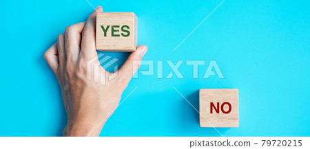 Hand choosing Yes or No block. Answer, question and decision concept 79720215