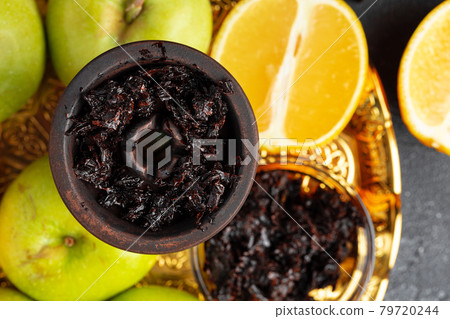 Shisha parts, tobacco and lemons close up Shisha parts, tobacco and lemons close up 79720244