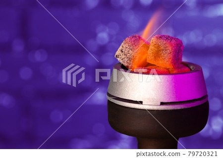 Burning hookah coals in hookah bowl close up Burning hookah coals in hookah bowl close up 79720321