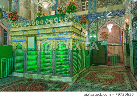 The tomb, holy shrine in the middle of the Shia mosque in Yazd, Iran. Small pieces of mirrors, glued on the walls of mosque, reflect the light beams and create beautiful colourful effects. The tomb, holy shrine in the middle of the Shia mosque in Yazd, Iran. Small pieces of mirrors, glued on the walls of mosque, reflect the light beams and create beautiful colourful effects. 79720636