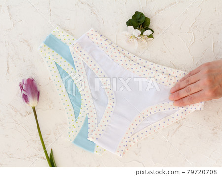 Woman's hand with beautiful panties on white background. Woman's hand with beautiful panties on white background. 79720708