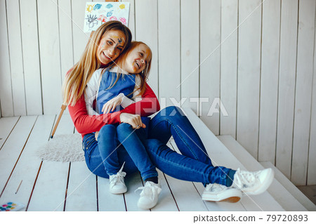 Mom and daughter are drawing 79720893