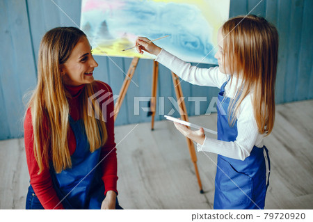 Mom and daughter are drawing 79720920