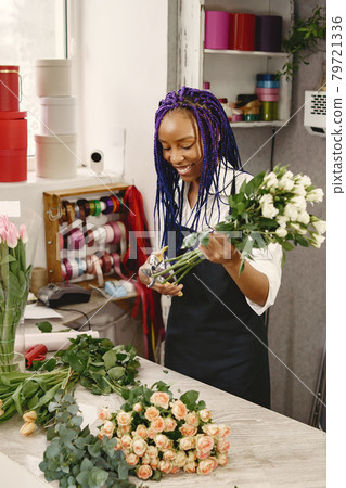 Portrait of joyful African American young woman in flower store Portrait of joyful African American young woman in flower store 79721336
