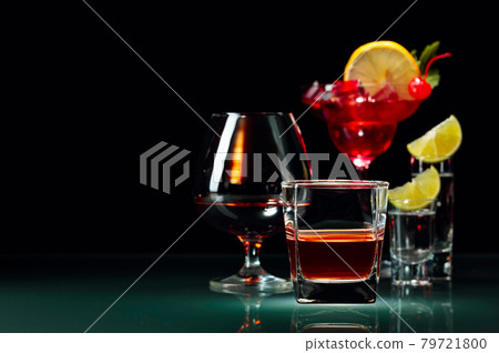 Various alcoholic drinks on a black background. 79721800