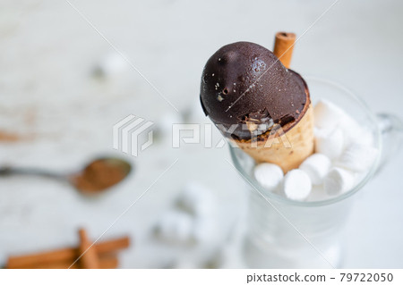 chocolate ice cream in a cone in a glass with marshmallows on a white background. Sweet dessert on the table. Composition with ice cream Sweet snack. view from above 79722050