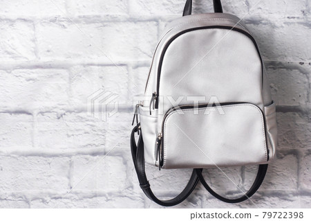 Shiny silver backpack on the background of a brick wall. Copy space Shiny silver backpack on the background of a brick wall. Copy space 79722398