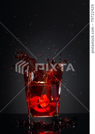 Cola glass with lemon and falling ice cubes. 79722429