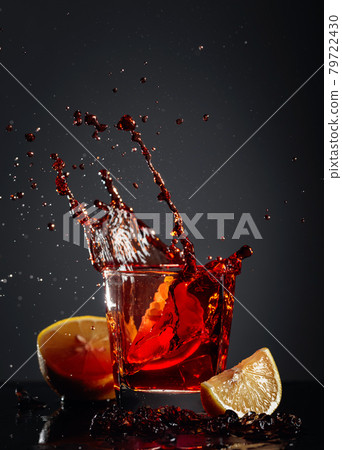 Cola glass with lemon and falling ice cubes. 79722430