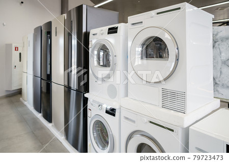 Row of new washing machines in a hypermarket Row of new washing machines in a hypermarket 79723473