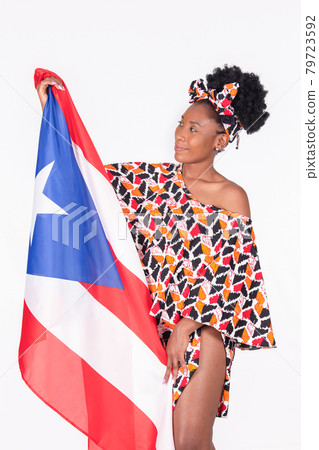 Beautiful latina woman looking at the flag of Puerto Rico with loving eyes: Patriotic concept 79723592