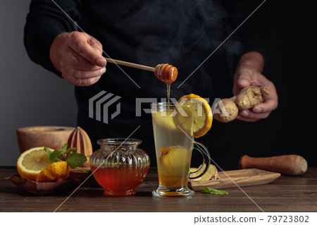 Hot ginger tea with lemon, mint and honey. Hot ginger tea with lemon, mint and honey. 79723802