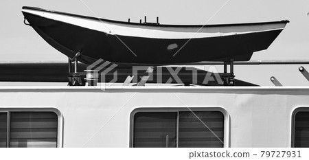 Lifeboat on the roof of a cargo ship for inland navigation, black and white 79727931