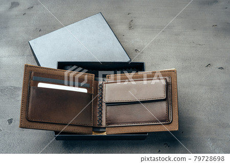 New brown leather wallet on dark background New brown leather wallet on dark background 79728698